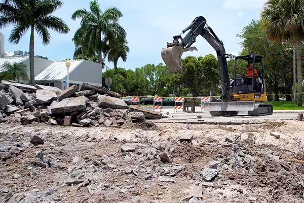 Excavator on a demolition debris pile