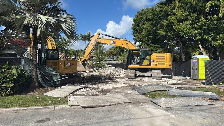 Excavators clearing a lot on an active site